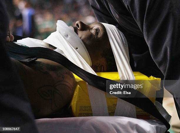 Marquis Daniels the Boston Celtics is taken off the court on a stretcher after colliding with Gilbert Arenas of the Orlando Magic on February 6, 2011...