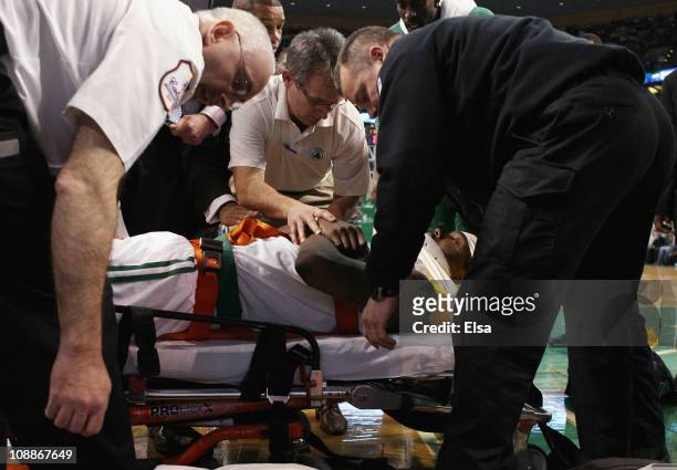 Marquis Daniels the Boston Celtics is taken off the court on a stretcher after colliding with Gilbert Arenas of the Orlando Magic on February 6, 2011...