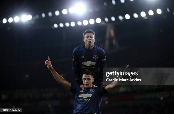 Alexis Sanchez of Manchester United celebrates scoring the opening goal with Jesse Lingard during the FA Cup Fourth Round match between Arsenal and...