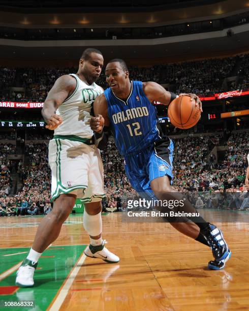 Dwight Howard of the Orlando Magic drives to the basket against Glen Davis of the Boston Celtics during the game on February 6, 2011 at the TD Garden...