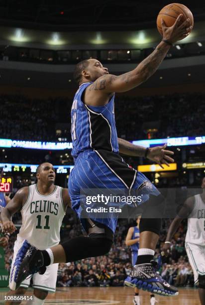 Jameer Nelson of the Orlando Magic heads for the basket past Glen Davis of the Boston Celtics on February 6, 2011 at the TD Garden in Boston,...