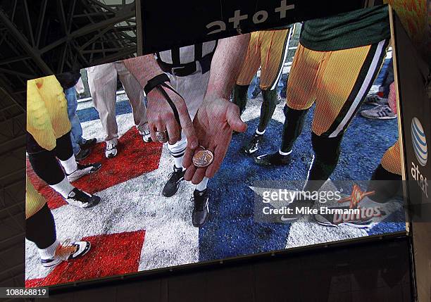 The coin toss is shown on the monitor during Super Bowl XLV at Cowboys Stadium on February 6, 2011 in Arlington, Texas.