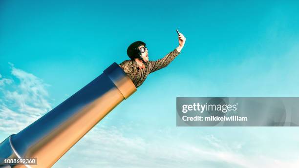 concept of fast 5g connection on mobile phone illustrated by daredevil and a cannon - practical joke stock pictures, royalty-free photos & images