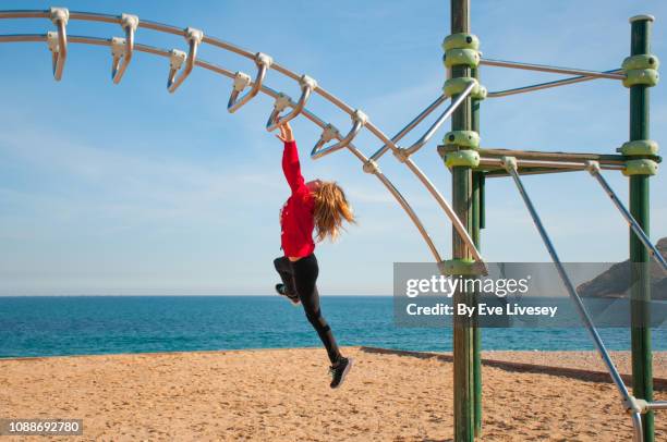 girl playing on a climbing frame - monkey bars stock pictures, royalty-free photos & images