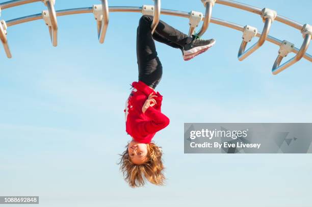 girl playing on a climbing frame - blaue schuhe stock-fotos und bilder