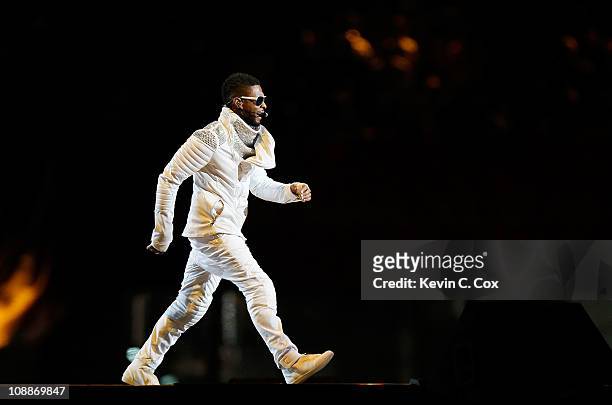 Usher performs with the Black Eyed Peas perform during the Bridgestone Super Bowl XLV Halftime Show at Cowboys Stadium on February 6, 2011 in...