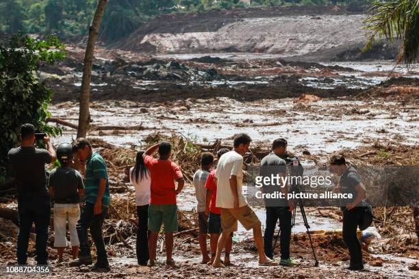 January 2019, Brazil, Brumadinho: People observe the mud masses after the break of a dam at the Feijão iron ore mine. Photo: Rodney Costa/dpa