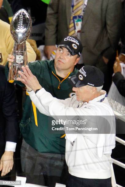 Head coach Mike McCarthy of the Green Bay Packers holds up The Vince Lombardi Trophy with General manager Ted Thompson after the Green Bay Packers...