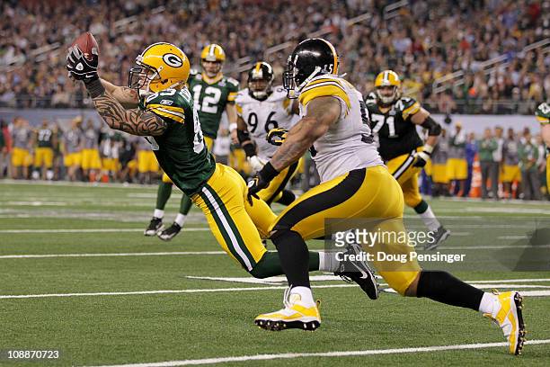 Tom Crabtree of the Green Bay Packers attempts to catch a ball infront of LaMarr Woodley of the Pittsburgh Steelers during Super Bowl XLV at Cowboys...
