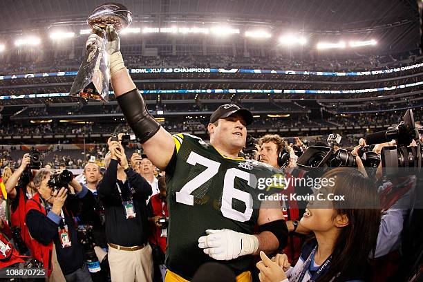 Chad Clifton of the Green Bay Packers holds up the Vince Lombardi Trophy after winning Super Bowl XLV 31-25 against the at Cowboys Stadium on...