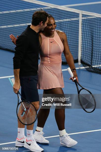 Serena Williams of the United walks off court with Roger Federer of Switzerland after the mixed doubles match during day four of the 2019 Hopman Cup...