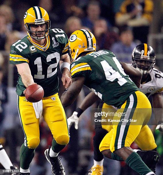 Green Bay Packers quarterback Aaron Rodgers hands off to Green Bay Packers running back James Starks in Super Bowl XLV where the Green Bay Packers...