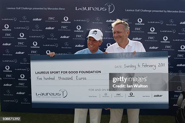 Academy Member Gary Player with Dr Joachim Schmidt and a big cheque after the Laureus Golf Challenge at the Saadiyat Beach Golf Club part of the 2011...