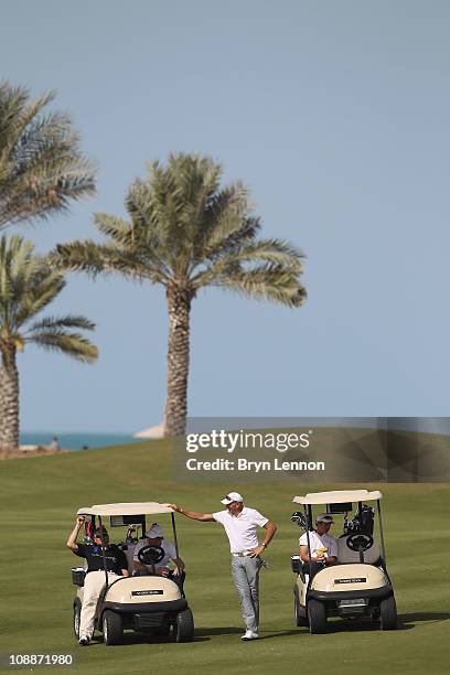 Academy Member Franz Klammer and Stefan Bloecher relax during the Laureus Golf Challenge at the Saadiyat Beach Golf Club part of the 2011 Laureus...