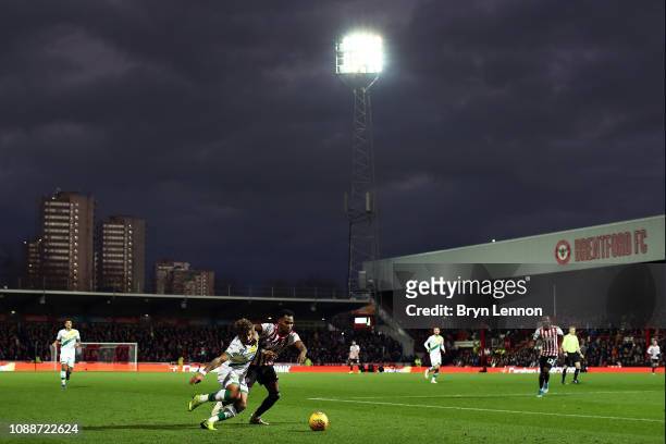 Rico Henry of Brentford tackles Onel Hernandez of Norwich City during the Sky Bet Championship match between Brentford and Norwich City at Griffin...