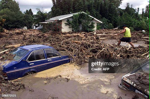 Ashton Matthews surveys the damage to the house of the late-Dame Whina Cooper after rains caused flooding and landslips to the small northland...