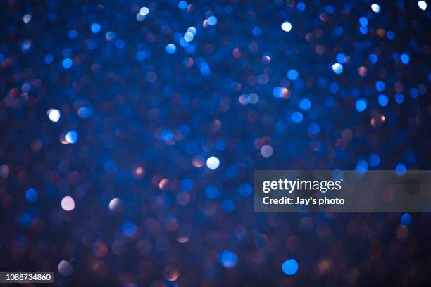 christmas winter bokeh light blue tones background - illuminated background stock pictures, royalty-free photos & images