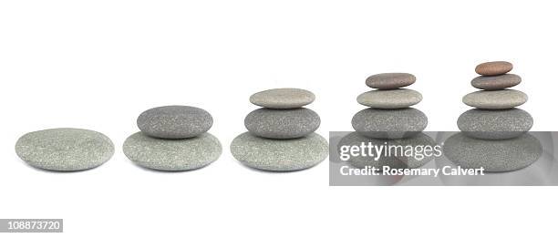 pebbles used to illustrate growth. - side by side comparison stock pictures, royalty-free photos & images