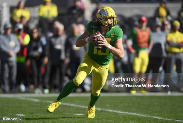 Justin Herbert of the Oregon Ducks looks to pass against the Michigan State Spartans during the first half of the Redbox Bowl at Levi's Stadium on...
