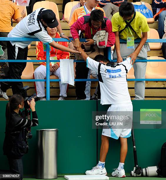 Yang Sheng Fa of Taiwan is congratulated by teammates as he celebrates his win with partner Li Chia Hung against Bae Hwan-Sung and Kim Tae-Jung of...