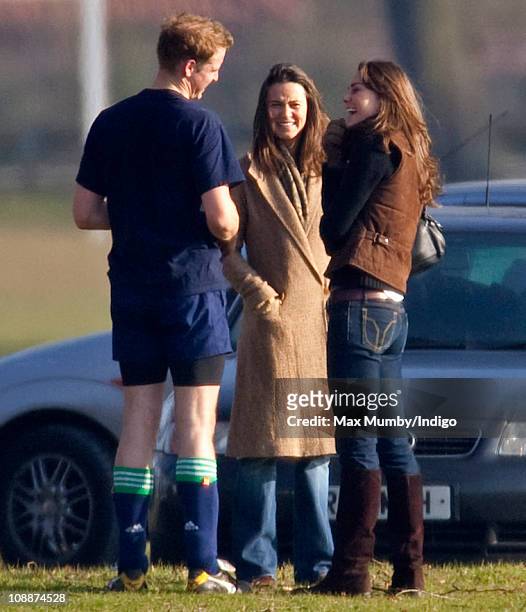 Prince William talks with Kate Middleton and her sister Pippa Middleton after playing the Field Game in an old boys match at Eton College on March...