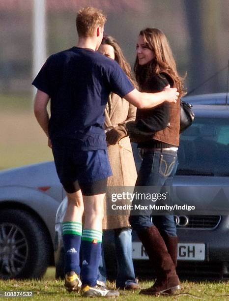 Prince William greets Kate Middleton and her sister Pippa Middleton after playing the Field Game in an old boys match at Eton College on March 18,...