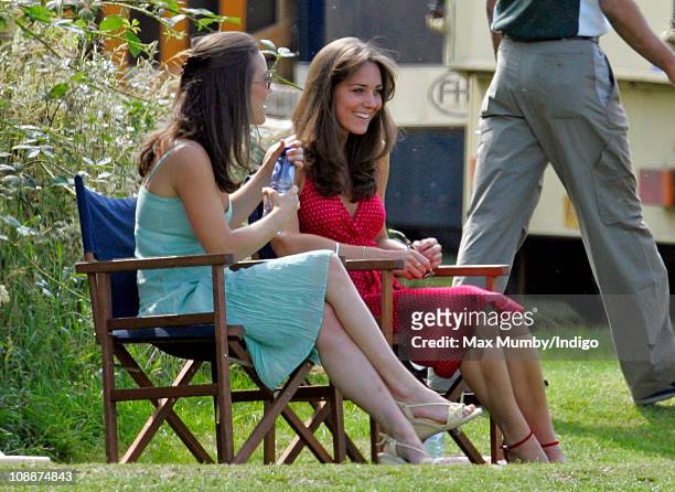Kate Middleton and her sister Pippa Middleton watch Prince William compete in the Chakravarty Cup charity polo match at Ham Polo Club on June 17,...