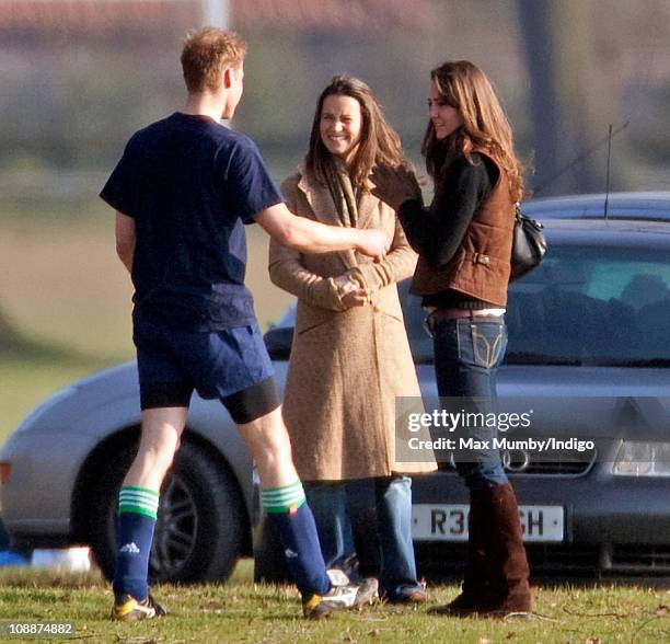 Prince William greets Kate Middleton and her sister Pippa Middleton after playing the Field Game in an old boys match at Eton College on March 18,...