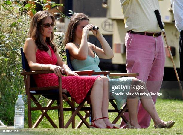 Kate Middleton and her sister Pippa Middleton watch Prince William compete in the Chakravarty Cup charity polo match at Ham Polo Club on June 17,...