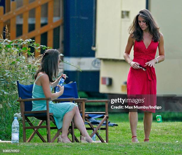 Kate Middleton and her sister Pippa Middleton watch Prince William compete in the Chakravarty Cup charity polo match at Ham Polo Club on June 17,...