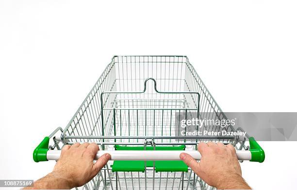 supermarket trolley with man's hands on white - ショッピングカート ストックフォトと画像