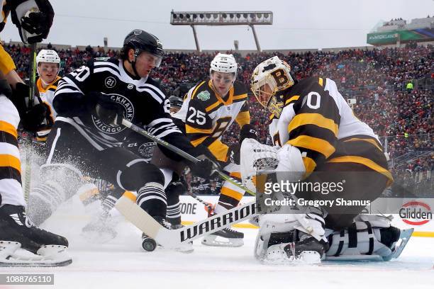 Brandon Saad of the Chicago Blackhawks attempts a shot past Tuukka Rask of the Boston Bruins in the second period during the 2019 Bridgestone NHL...