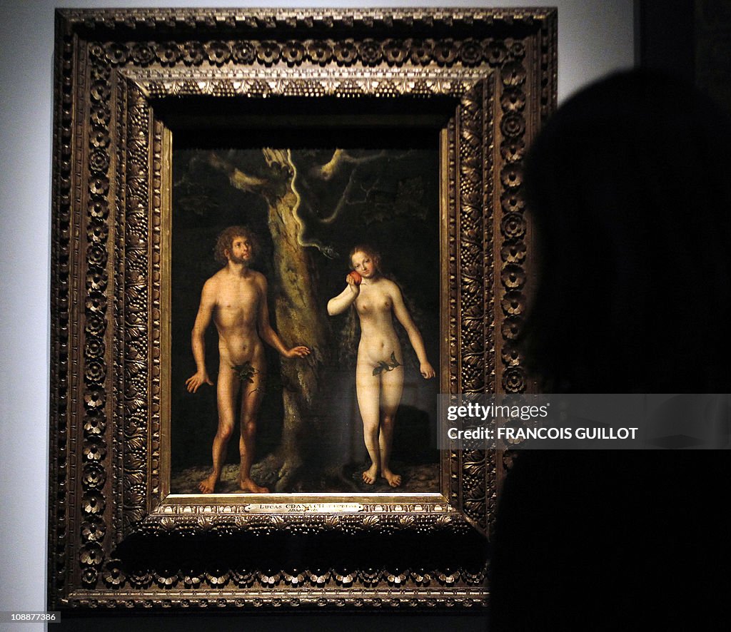 A woman looks at a painting entitled "Ad