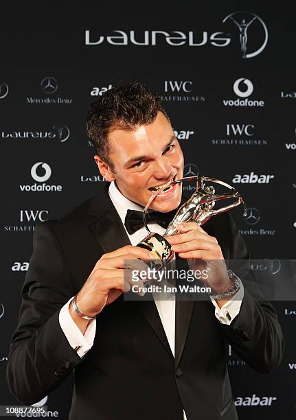 Golfer Martin Kaymer of Germany poses with his award for Laureus World Breakthrough of the Year in the winners studio at the 2011 Laureus World...