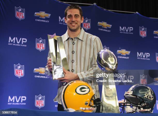 Green Bay Packers quarterback Aaron Rodgers poses with the MVP trophy after speaking to the media during a press conference at Super Bowl XLV Media...
