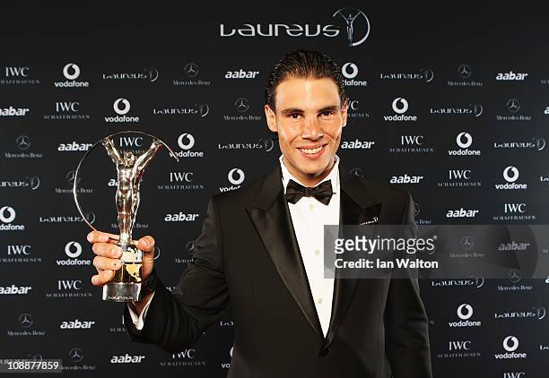 Tennis Player Rafael Nadal of Spain poses with his award for Laureus World Sportsman of the Year in the winners studio at the 2011 Laureus World...