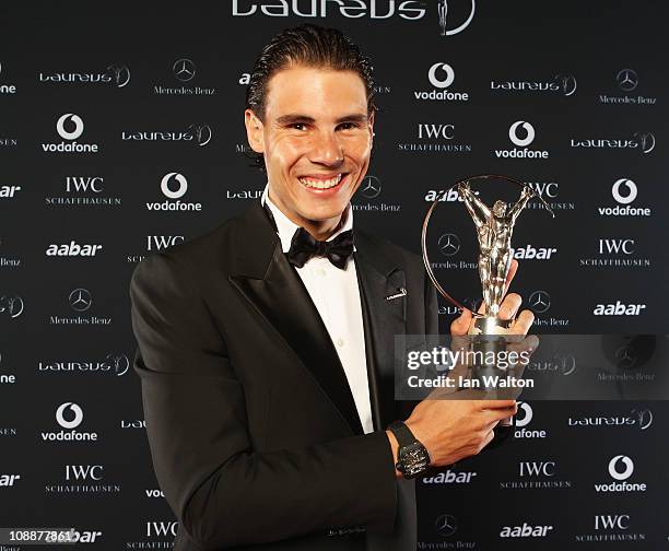 Tennis Player Rafael Nadal of Spain poses with his award for Laureus World Sportsman of the Year in the winners studio at the 2011 Laureus World...