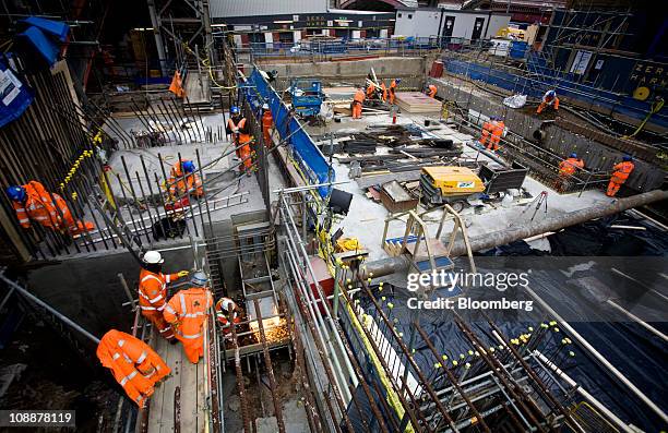 Workers labor on the Balfour Beatty construction site at the Blackfriars Bridge station development in London, U.K., on Friday, Feb. 4, 2011. Balfour...