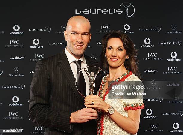 Zinedine Zidane and guest pose with his award for Laureus Lifetime Achievement Award in the winners studio at the 2011 Laureus World Sports Awards...