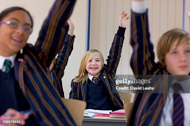 group of children in school - schooluniform stockfoto's en -beelden