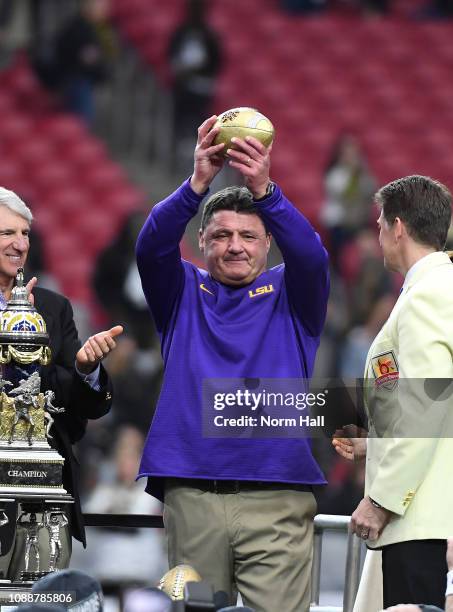Head coach Ed Orgeron of the LSU Tigers holds the championship trophy after the Tigers defeated the UCF Knights 40-32 in the PlayStation Fiesta Bowl...