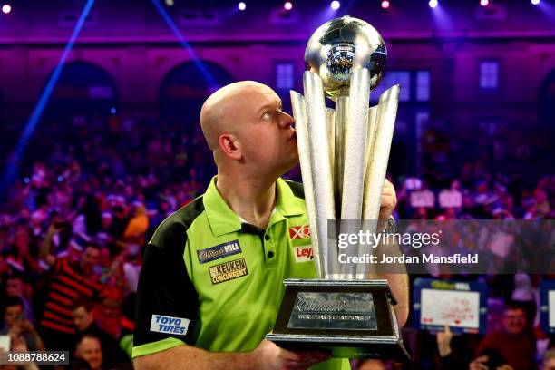 Michael van Gerwen of the Netherlands poses with the trophy after victory in the Final match against Michael Smith of England during Day 17 of the...