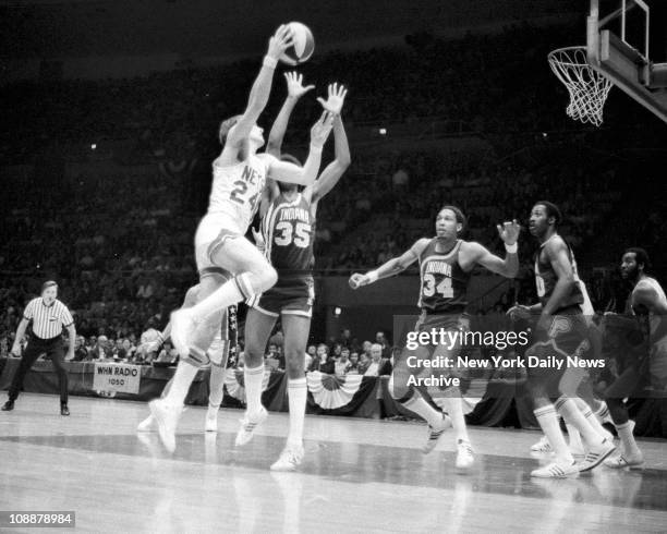 Basketball Nets vs Indiana. Rick Barry shoots over Pacers' Roger Brown , Mel Daniels and George McGinnis for two points, while Nets' Trooper...