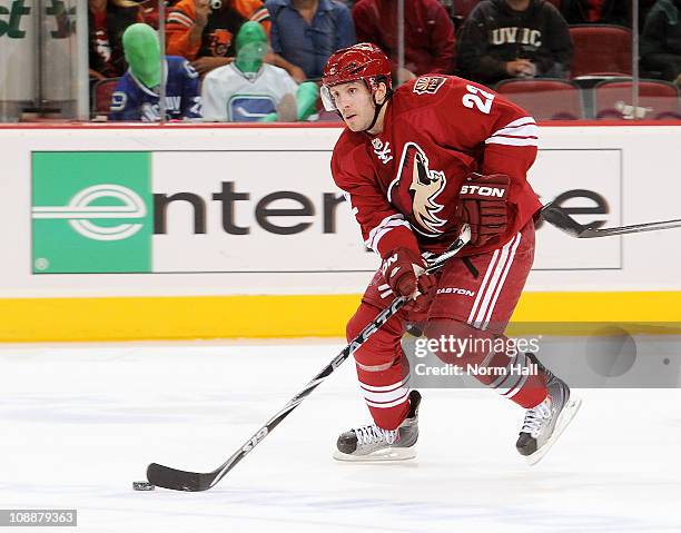 Lee Stempniak of the Phoenix Coyotes skates the puck up ice against the Vancouver Canucks on February 2, 2011 at Jobing.com Arena in Glendale,...