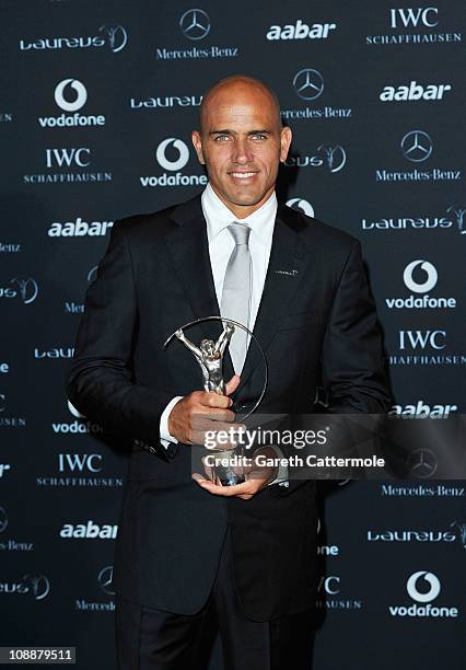 Surfer Kelly Slater of the United States poses with his award for Laureus World Action Sportsperson of the Year in the winners studio at the 2011...