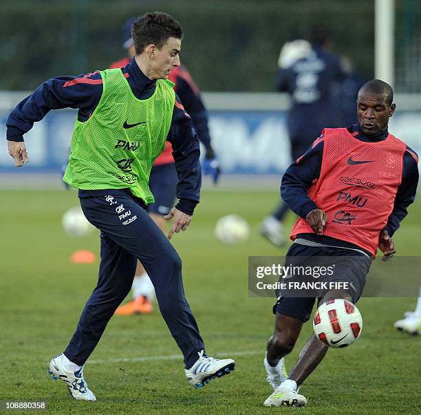 French national soccer team's defender Laurent Koscielny vies with counterpart Eric Abidal during a training session, on February 7, 2011 in...
