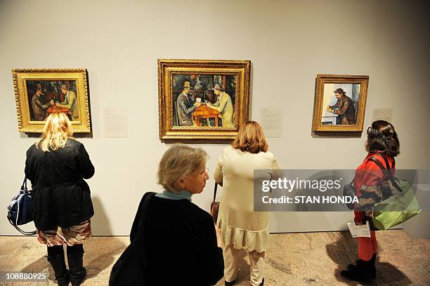 Visitors look at versions of "The Card Players" 1892-96 and "The Card Player" 1892-96 by Paul Cézanne on February 7, 2011 at the Metropolitan Museum...