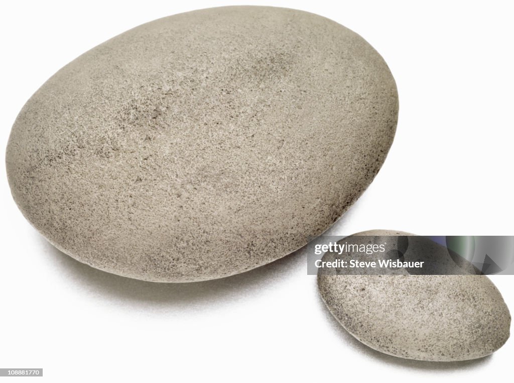 A large and small well rounded smooth river stones