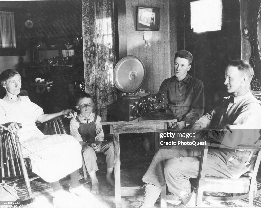 Getty Rudia A family gathers around and listens to the radio, Hood River, Oregon ...