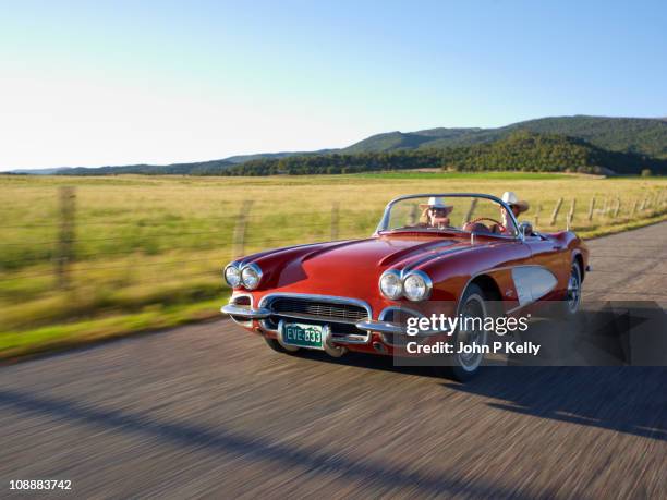 two women in red convertible - auto convertibile photos et images de collection